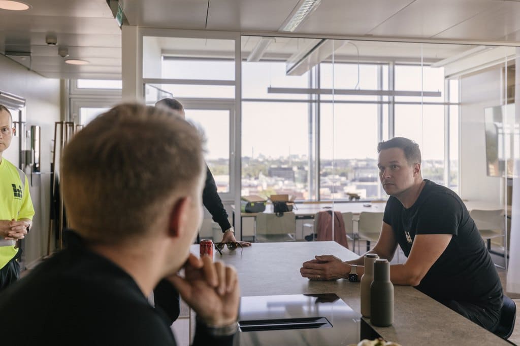 Louhintahiekan henkilöstöä istumassa pöydän äärellä valoisissa toimitiloissa